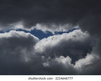 Dark Rain Clouds With A Streak Of Blue Sky