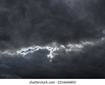 Dark Rain Clouds With A Streak Of Blue Sky