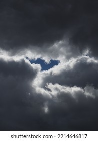 Dark Rain Clouds With A Streak Of Blue Sky