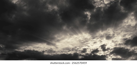 Dark rain clouds and sun rays at sunset. Web banner. Panorama. For design. - Powered by Shutterstock - Get 15% off with code: PIKWIZARD15