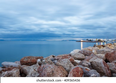 Dark Rainy Sky And Rocks At The Beach In Greece