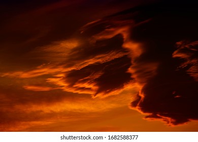 Dark red cloudy sky after sunset. Gloomy atmoshpere.