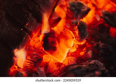 Dark red coals and burnt piece of paper in the form of heart, close up. Concept of broken heart, end of relationships and devastation - Shutterstock ID 2245059319