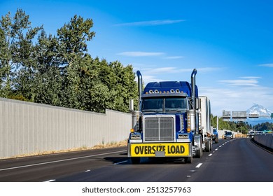 Dark red long haul industrial big rig semi truck tractor with extended cab for truck driver rest transporting fastened cargo on flat bed semi trailer running on the flan highway road at sunset time - Powered by Shutterstock