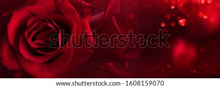 Dark red roses background with luminous bokeh and abstrakt hearts. Love concept for valentines day and wedding. Space for text and design.
