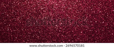 Dark red sparkling background from small sequins, macro. Shiny wine glitter backdrop for Christmas or New Year.