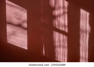 A Dark Red Wall With Beautiful Sun Light And Window Frame Shadow Shine On. Background. Morning Sunlight Shine Through  The Window  On Dark Green Wall Inside The Room.