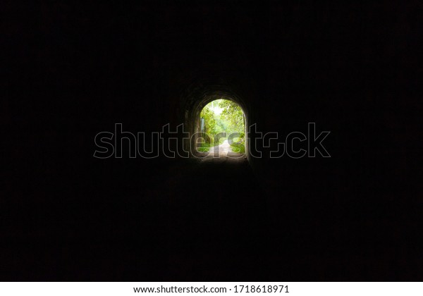 Dark road in a tunnel to\
the light