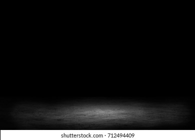 Dark room with tile floor and brick wall background - Shutterstock ID 712494409