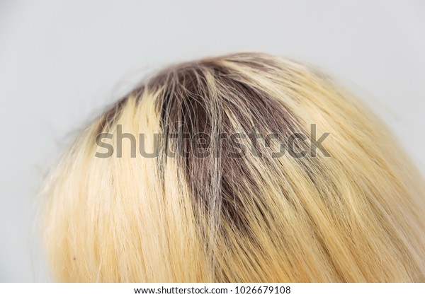 dark roots of hair,
overgrown hair