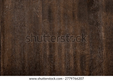Dark rustic wood texture background, weathered vintage brown timber surface for interior design, top view of aged wooden table plank, natural organic grain backdrop for product photography.