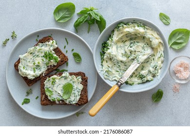 dark rye bread sandwichs with herbs butter,  ligth concrete background, top view - Powered by Shutterstock