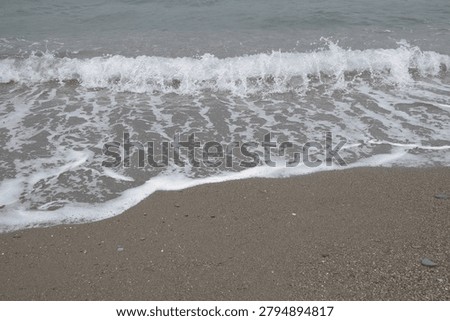 dark sand tranquility wave reaching the seashore relaxation