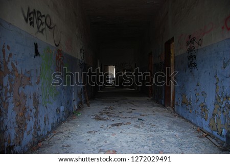 Dark and scary corridor of abandoned decay building, urbex
