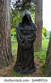 Dark Scene Of A Black Hooded Monk In The Woods