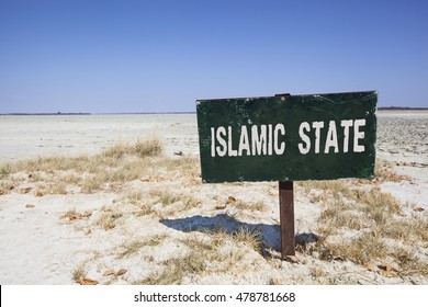 Dark Sign In The Desert With The Words Islamic State In White Letters. Political Concept Concerning Terrorism And The War In Syria And Iraq