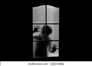 Dark silhouette girl behind glass  Locked alone in room behind door Halloween in grayscale  Nightmare child and aliens  monsters   ghosts  Evil in home in monochrome  Inside haunted house 