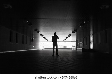 Dark Silhouette Of A Man Making An Anonymous Phone Call.