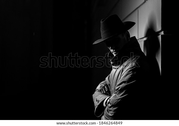dark silhouette of a man in a\
raincoat with a hat at night on the street in a crime Noir\
style