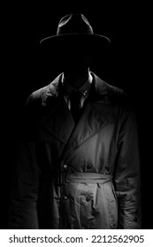 A Dark Silhouette Of A Man Without A Face In A Coat And Hat In The Noir Style. A Dramatic Portrait In The Style Of Detective Films Of The 1950s And 60s. The Silhouette Of A Spy.