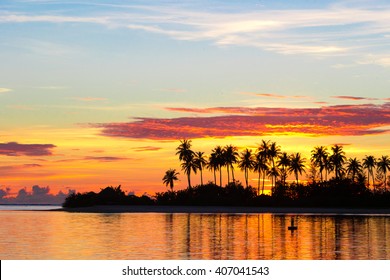 Dark silhouettes of palm trees and amazing cloudy sky on sunset at tropical island in Indian Ocean - Powered by Shutterstock