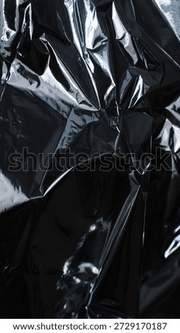 Dark silver foil texture with angular folds and glossy highlights