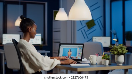 Dark skin freelancer retoucher woman working overtime laptop and photo editing software  Professional graphic editor retouching photo client during night time in home office performance pc