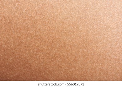 Dark skin of woman hand macro. Human skin texture background