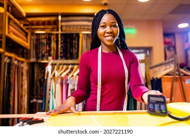 Dark Skinned Business Woman Salewoman Working At Textile Shop