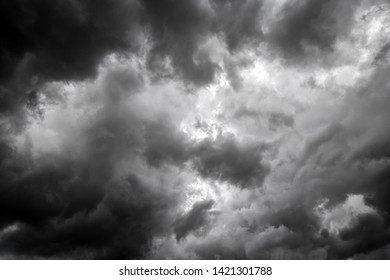 Dark Sky And Dramatic Black Cloud Before Rain.A Tropical Cyclone Is A Rapidly Rotating Storm System Characterized By A Low-pressure Center, A Closed Low-level Atmospheric Circulation, Strong Winds. 