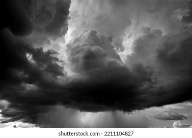 Dark Sky And Dramatic Black Cloud Before Rain.A Tropical Cyclone Is A Rapidly Rotating Storm System Characterized By A Low-pressure Center, A Closed Low-level Atmospheric Circulation, Strong Winds.