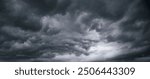 The dark sky with heavy clouds converging and a violent storm before the rain.Bad or moody weather sky and environment. carbon dioxide emissions, greenhouse effect, global warming, climate change.