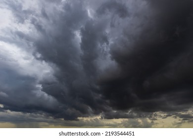 The dark sky with heavy clouds converging and a violent storm before the rain.Bad weather sky.