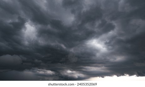 The dark sky with heavy clouds converging and a violent storm before the rain.Bad or night weather sky and environment. carbon dioxide emissions, greenhouse effect, global warming, climate change