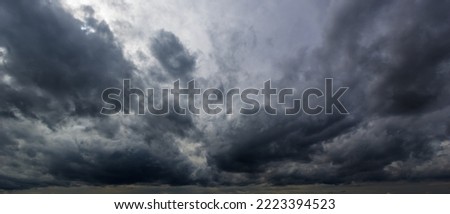 The dark sky with heavy clouds converging and a violent storm before the rain.Bad or moody weather sky and environment. carbon dioxide emissions, greenhouse effect, global warming, climate change