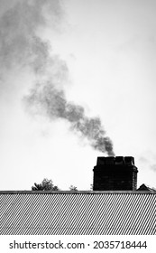 Dark Smoke Cloud From Chimney Smoke Stack In Black And White. Air Polution, Carbon Emissions, Climate Emergency, 