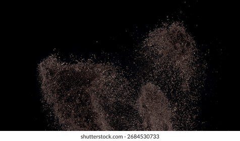 Dark Soil or Dust Particles Exploding on Black Background