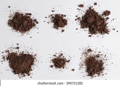 Dark Soil Isolated On White Background. Pile Of Dirt And Stones. Top View Of A Heap Of Ground. Close Up Macro View Collection