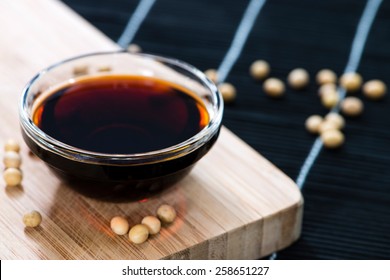 Dark Soy Sauce (close-up Shot) On Bamboo Background