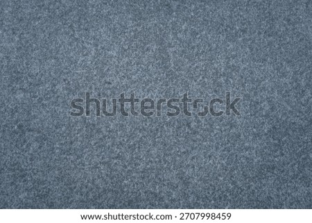 dark speckled gray surface background texture with fine granular pattern concept of acoustic paneling, textile design, stone products.