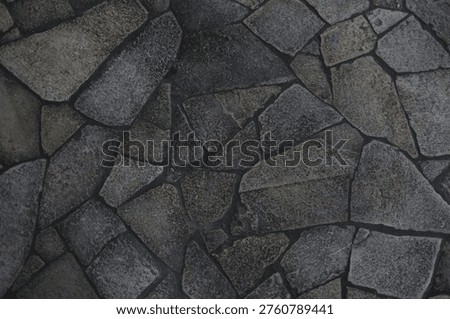 Dark stone pavement texture with irregular geometric rock pattern