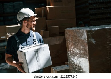 In Dark Store. Employee In Uniform Is Working In The Storage.