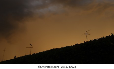 Dark Storm Cell Approaching Suburban Town At Sunset During Australian Spring.