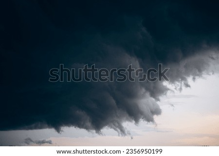 a dark storm cloud is approaching the city