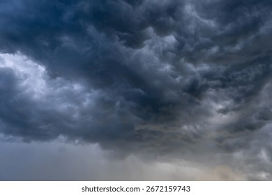 Dark storm clouds in dramatic sky with moody atmosphere and heavy overcast before rain or thunderstorm