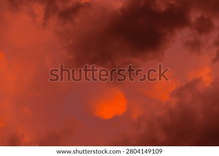 Dark storm clouds gather in the sky, illuminated by flashes of orange light, hinting at an approaching thunderstorm. The mood is tense, evoking a sense of wonder and fear.