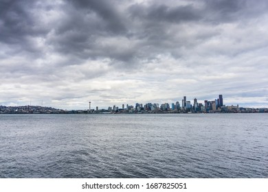 Dark storm clouds hover over the Seattle skyline.