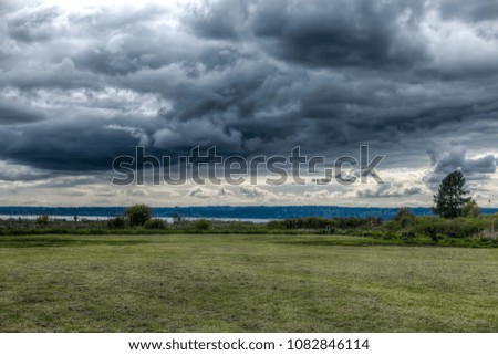 Similar – Foto Bild Stürme dunkle Wolken über dem Feld. Gewitter über einem Weizenfeld