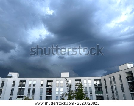 Dark storm clouds over modern residential buildings