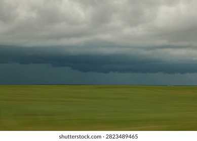 Dark Storm Clouds Over Open Grassland Horizon With Dramatic Approaching Thunderstorm And Ominous Sky